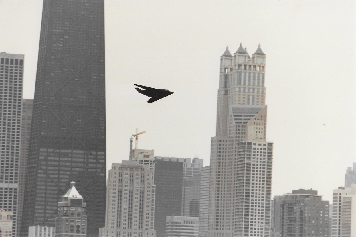 An F-117 stealth fighter over the Chicago skyline at the 1990 Air and Water Show