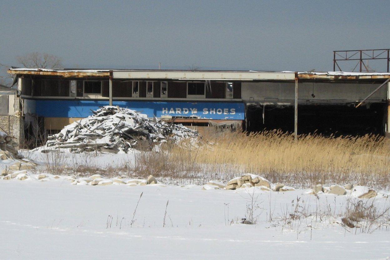 The abandoned Hardy Shoes storefront at Dixie Square Mall, with snow and rubble in front