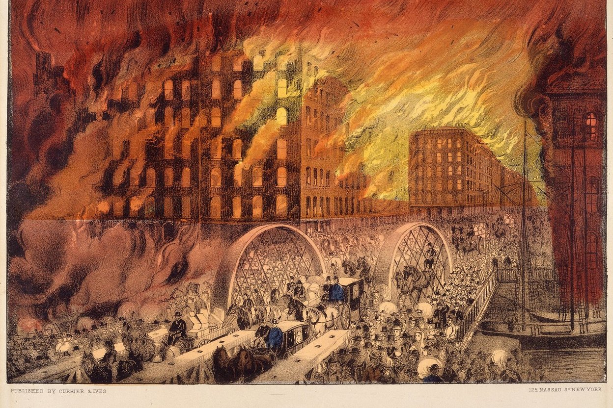 1871 photograph of downtown Chicago after the Great Fire, with burned-out stone walls and rubble stretching toward the lake