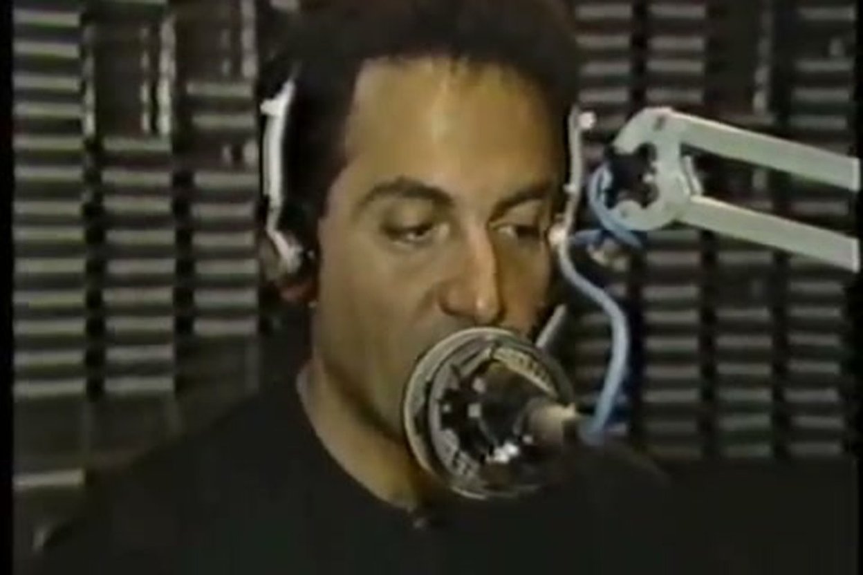 Jonathon Brandmeier on stage with a microphone