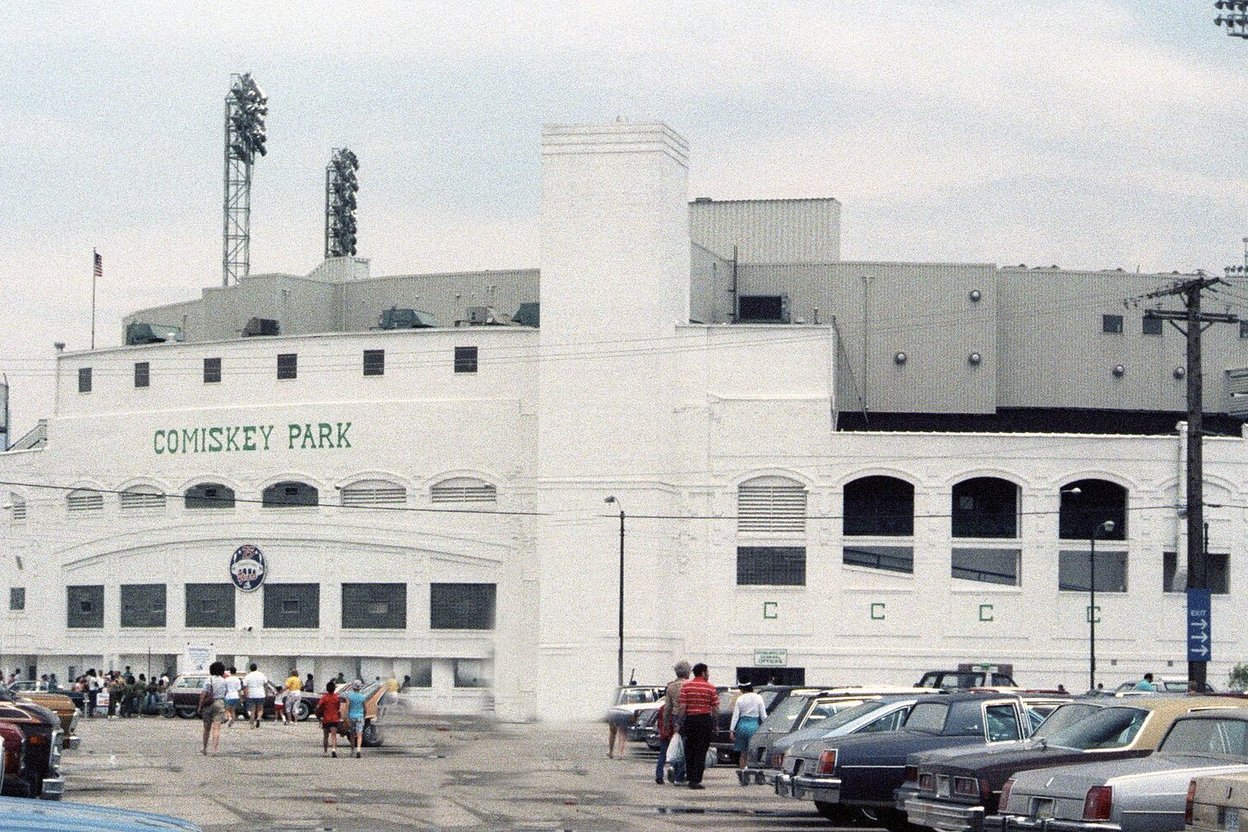 The white exterior of old Comiskey Park in Chicago in 1986, with cars parked outside