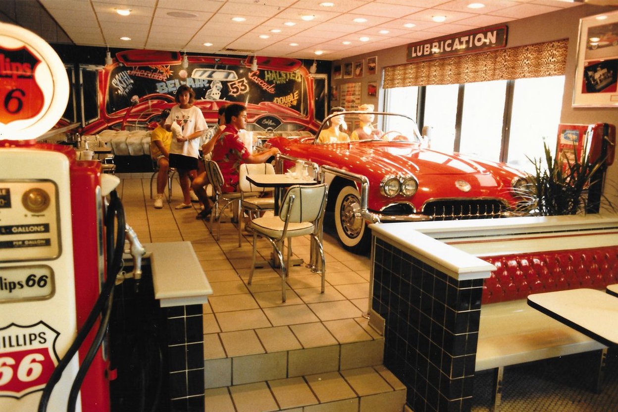 Inside the Rock 'n' Roll McDonald's in Chicago in 1986, with a vintage red convertible on display