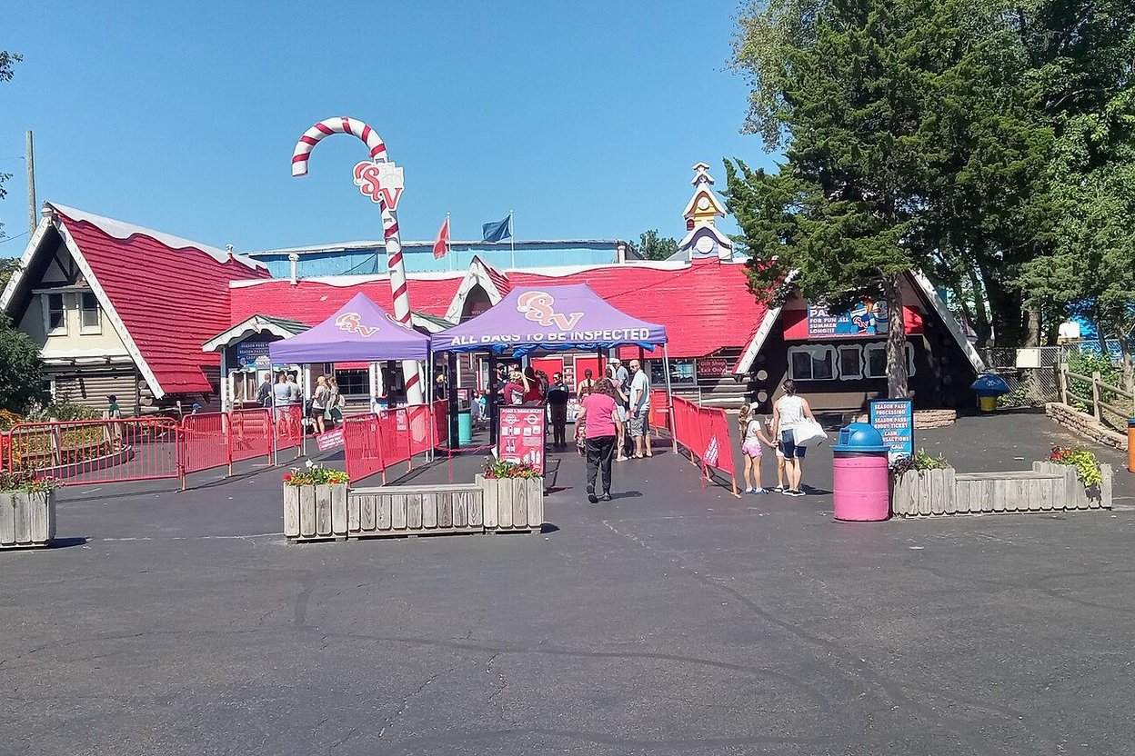 The red-roofed entrance gate of Santa's Village in East Dundee, with a candy-cane arch