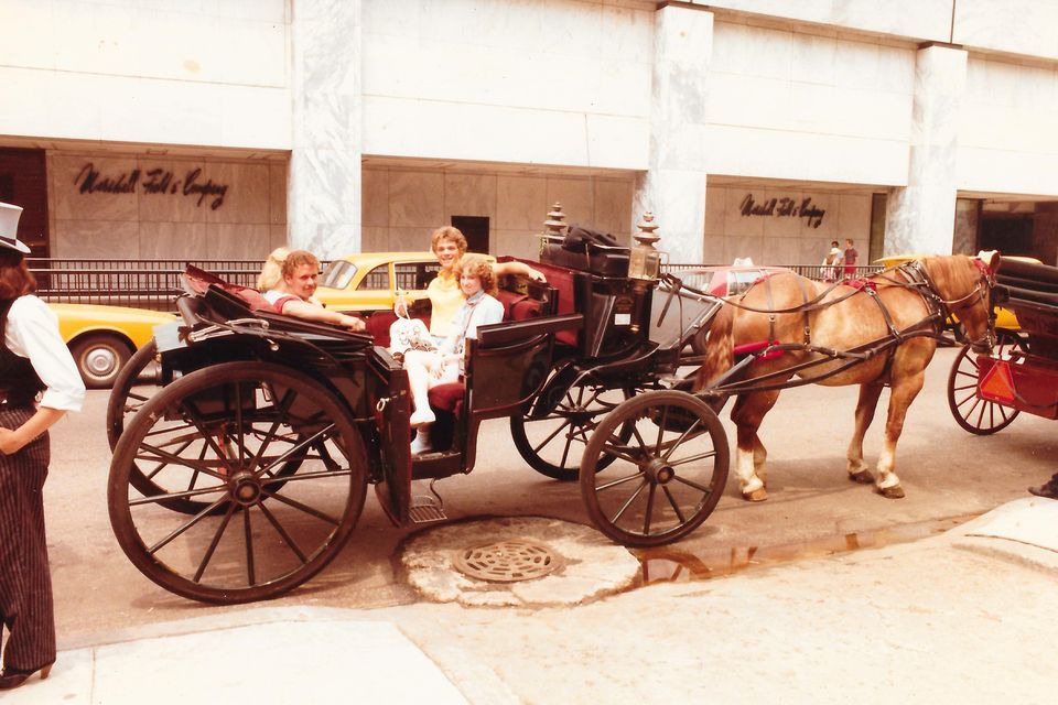 A horse-drawn carriage in front of a Marshall Field & Company store, July 1984